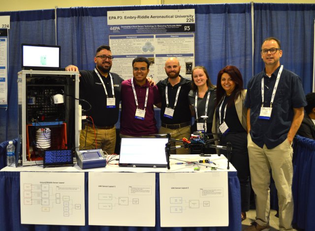 4.	The Embry-Riddle Aeronautical University team with their low-cost air quality sensor and drone, which they used to measure atmospheric particulate matter levels.