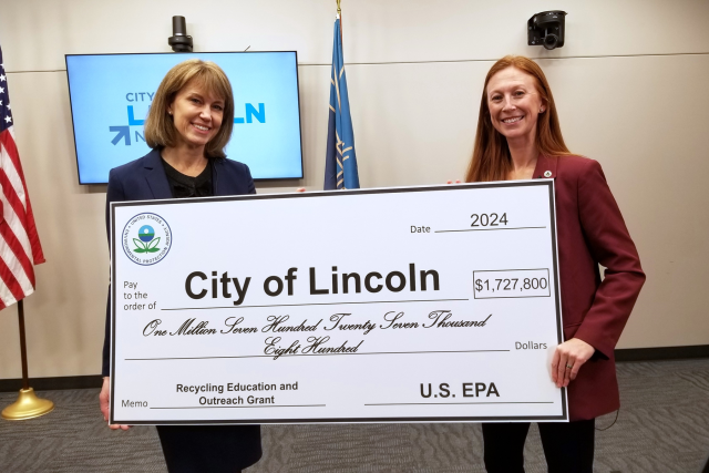 Leirion Gaylor Baird, mayor of Lincoln, Nebraska, accepts a $1,727,800 ceremonial check for a Recycling Education and Outreach Grant from EPA Region 7 Administrator Meg McCollister on Jan. 25, 2024