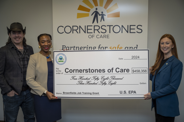 EPA Region 7 Administrator Meg McCollister (right) presents a $458,358 check to Cornerstones of Care President and CEO Merideth Rose and Build Trybe Director Theo Bunch during a ceremony in Kansas City, Missouri, on Feb. 1, 2024.