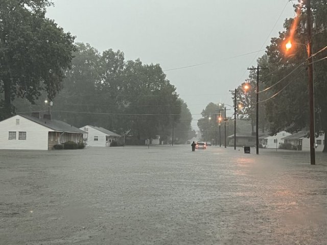 Extreme flooding in a residential neighborhood during a storm.