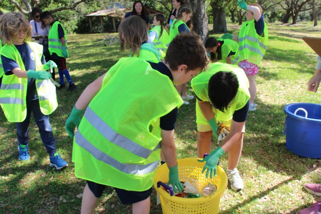 Children collect trash and place it in containers for recycling
