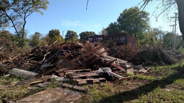 Depicts illegal disposal of wood and debris 