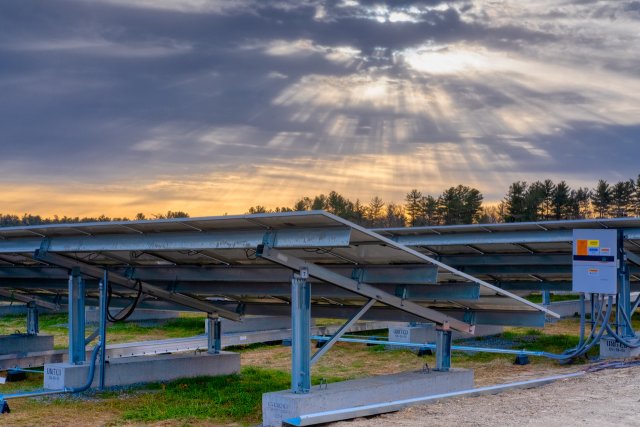 Close-up photograph of a solar array, showing the structural supports on the underside of each panel