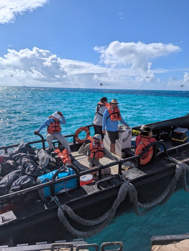 Workers on a boat hauling materials near Tern Island