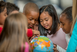 Children looking at a globe