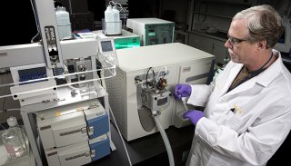 Photo of liquid chromatography-mass spectrometry laboratory equipment and staff