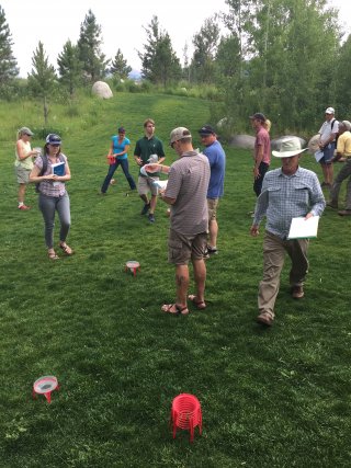 People checking the grass as part of an irrigation audit.