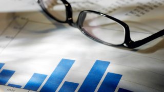 Image of a pair of glasses resting on some paperwork.