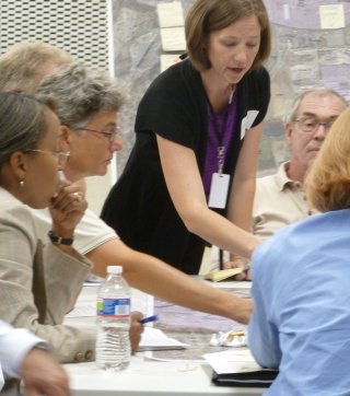 A facilitator leads a group meeting about site redevelopment