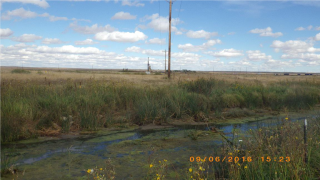 View from Blacktail Creek to the well pad along electric powerlines.