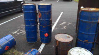 Drums of hazardous waste abandoned in parking lots outside apartment complexes in Columbus, OH