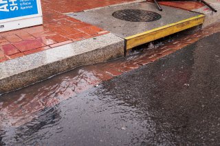 Water flowing from the street into a storm drain