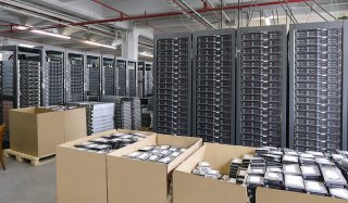 Wide shot of electronics in cardboard boxes for recycling.