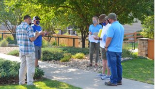 People on a yard conducting a landscape consultation.