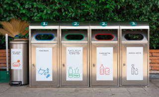 This is a picture of five bins clearly labeled to indicate what should go in each one - food waste, general trash, glass, plastic, and aluminum. 