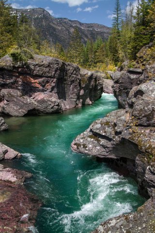 A stream rushes between walls of rocks.