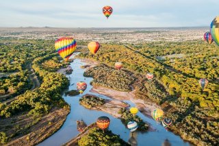 Hot Air balloons hover over the Rio Grande.