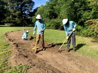 Community members planting seeds.