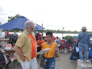 A volunteer in Buffalo talking to a community member about the air monitoring project.