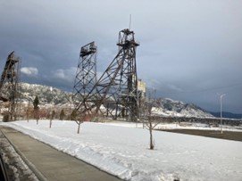 Historic mining frames on a snow-covered landscape.