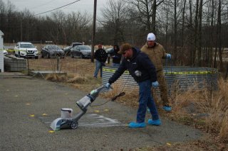 A researchers vacuums outside