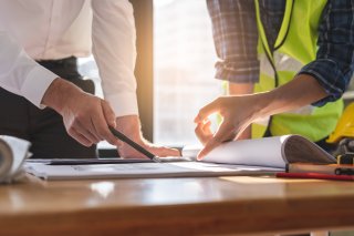 people pointing at paper