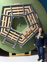 Figure 1: Researcher Laurie Brixey in front of the Pentagon model