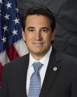 Professional photo of Michael Molina in front of the American flag
